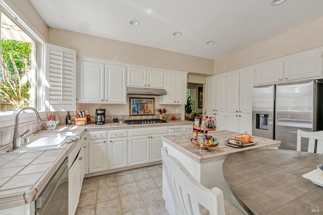 2035 Kirkwood Ct, Fairfield, CA 94534 - kitchen featuring tile counters, stainless steel appliances, a sink, white cabinetry, and recessed lighting