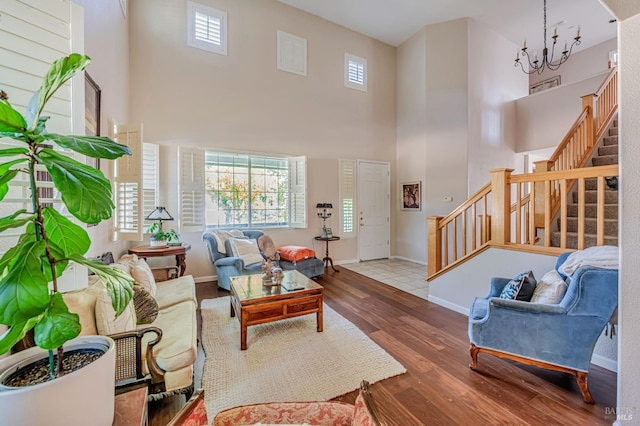 2035 Kirkwood Ct, Fairfield, CA 94534 - living room with wood finished floors, a towering ceiling, stairway, baseboards, and a chandelier