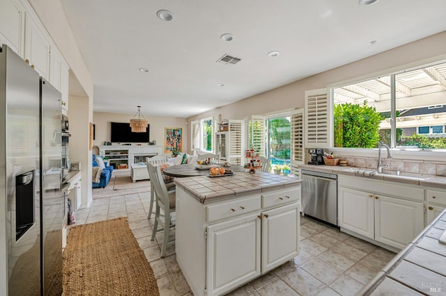 2035 Kirkwood Ct, Fairfield, CA 94534 - kitchen with stainless steel appliances, a sink, tile countertops, white cabinets, and recessed lighting