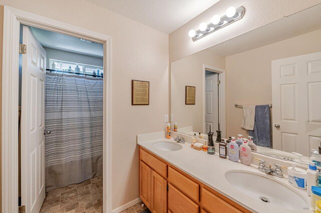 2035 Kirkwood Ct, Fairfield, CA 94534 - bathroom featuring double vanity, stone finish flooring, and curtained shower