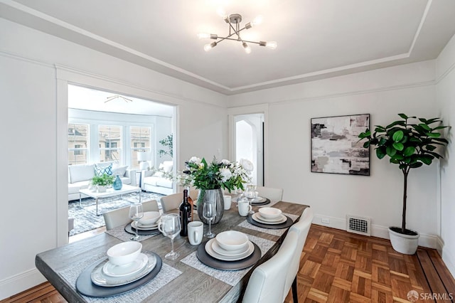dining area with an inviting chandelier, baseboards, and visible vents