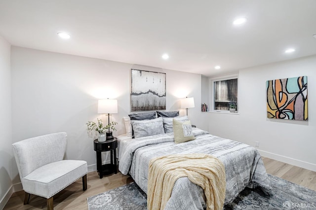 bedroom with recessed lighting, baseboards, and light wood-type flooring