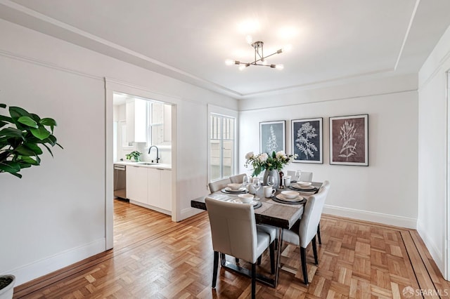 dining area with baseboards and a chandelier