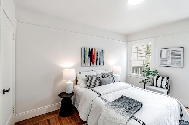 bedroom featuring baseboards and wood finished floors