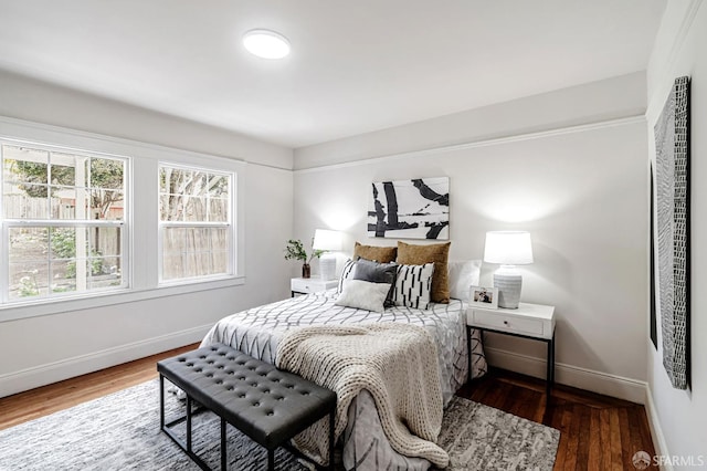 bedroom with baseboards and wood finished floors