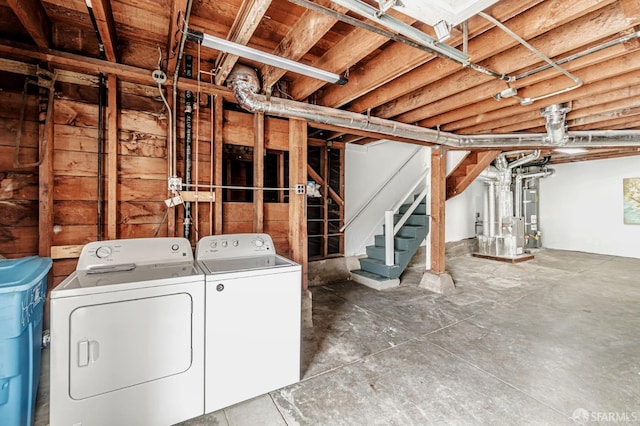 below grade area featuring washing machine and clothes dryer and stairway