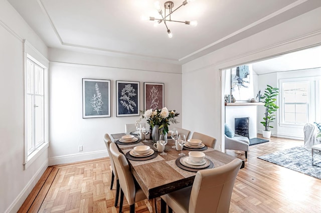 dining room with baseboards and a notable chandelier