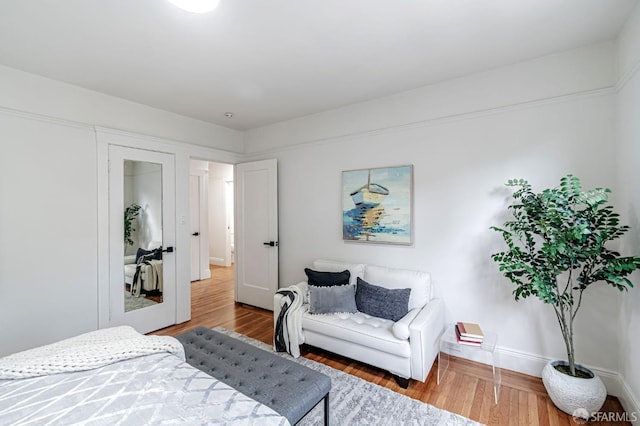 bedroom featuring baseboards and wood finished floors