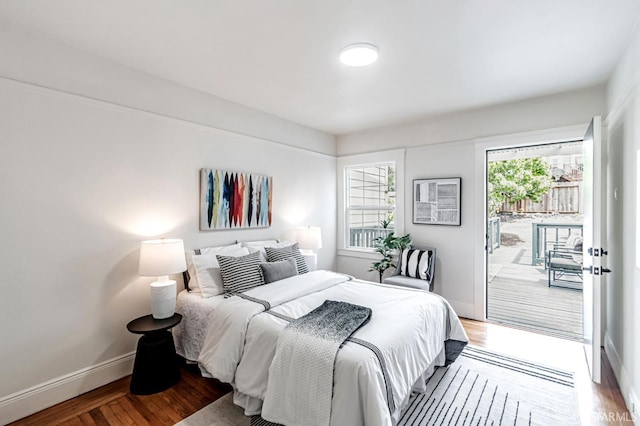 bedroom with access to outside, baseboards, and wood finished floors