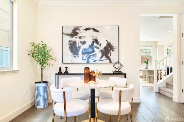 dining area with dark hardwood / wood-style flooring and ornamental molding