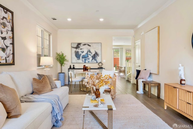 living room with hardwood / wood-style flooring and ornamental molding