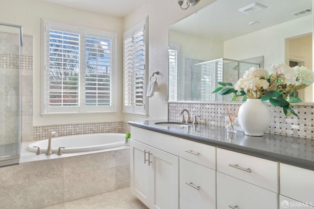 bathroom with vanity, tile patterned floors, and separate shower and tub