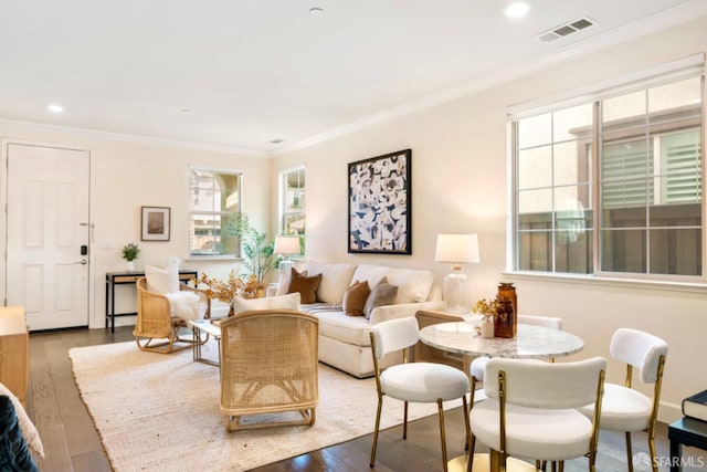 living room with wood-type flooring and crown molding