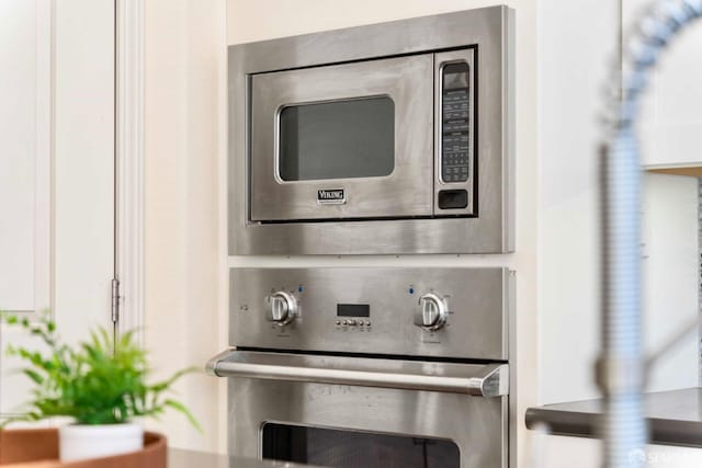 interior details featuring white cabinets and stainless steel appliances