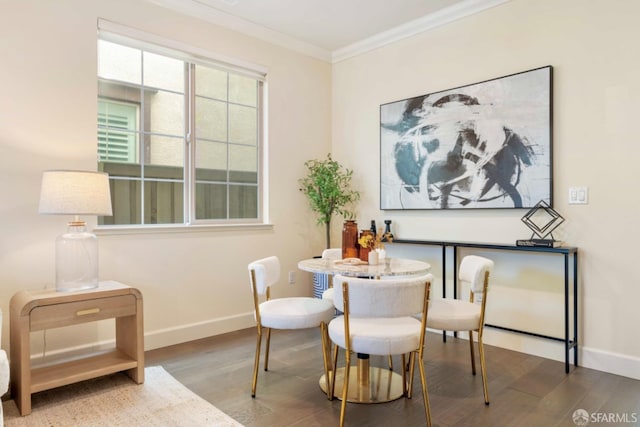 dining space featuring hardwood / wood-style flooring and ornamental molding