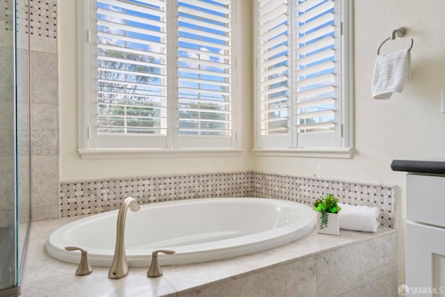 bathroom featuring tiled bath