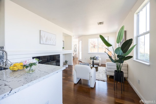 3044 Whisperwave Cir, Redwood City, CA 94065 - living area with dark wood finished floors, a glass covered fireplace, and baseboards