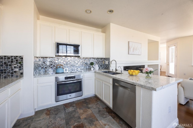 3044 Whisperwave Cir, Redwood City, CA 94065 - kitchen with stainless steel appliances, a peninsula, decorative backsplash, white cabinets, and recessed lighting