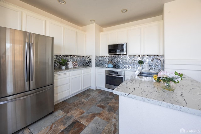 3044 Whisperwave Cir, Redwood City, CA 94065 - kitchen featuring stainless steel appliances, a sink, tasteful backsplash, dark stone finish floors, and white cabinetry