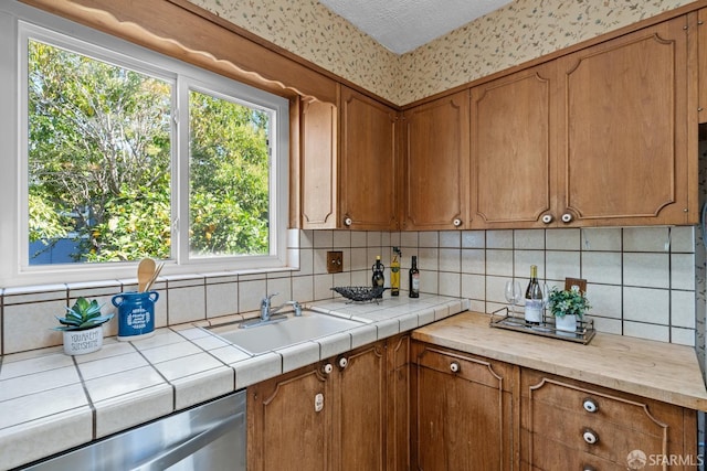 532 Vista Ct, Millbrae, CA 94030 - kitchen featuring stainless steel dishwasher, backsplash, brown cabinets, and plenty of natural light