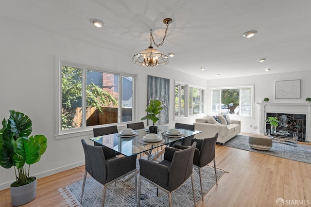 532 Vista Ct, Millbrae, CA 94030 - dining area with light wood-style floors, a chandelier, and a fireplace