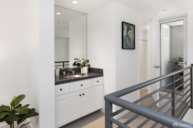 hall with recessed lighting and a sink