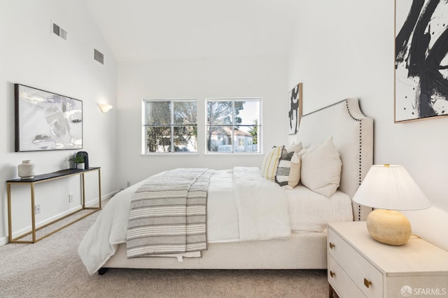 carpeted bedroom with lofted ceiling