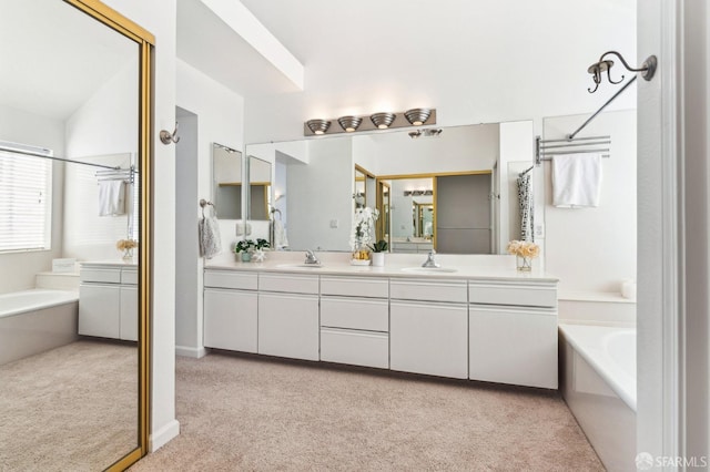 bathroom featuring vaulted ceiling, vanity, and independent shower and bath