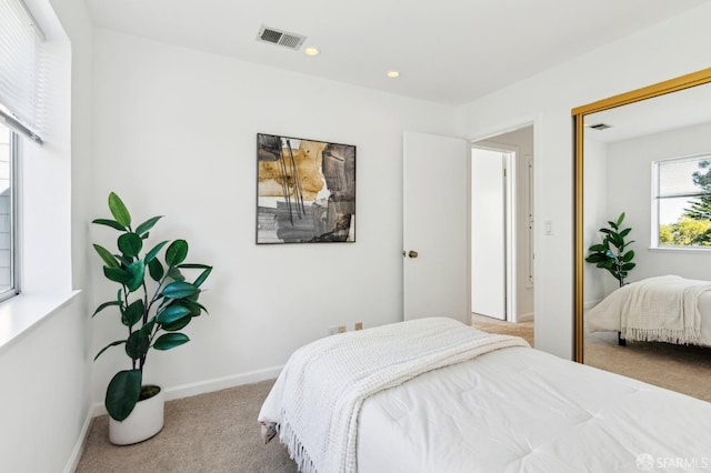 bedroom featuring light colored carpet