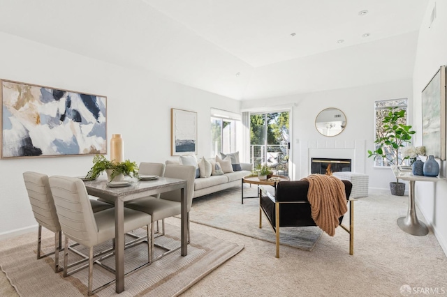 carpeted living room with lofted ceiling