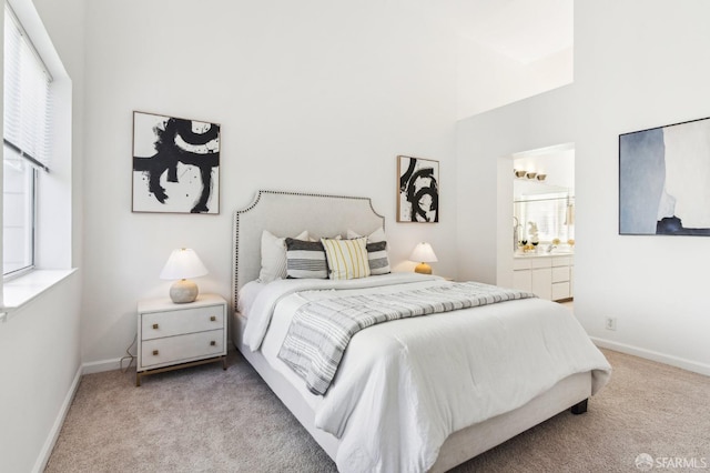 carpeted bedroom featuring connected bathroom