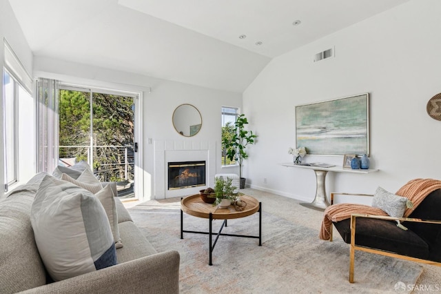 living room with vaulted ceiling and light carpet