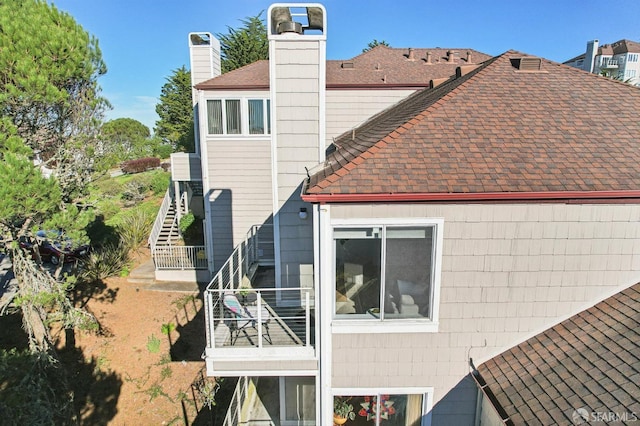 rear view of property with a balcony