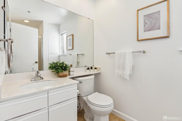 bathroom featuring toilet and vanity