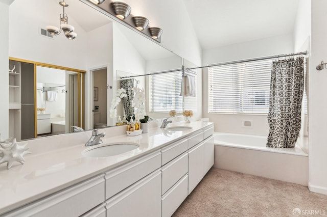 bathroom with lofted ceiling, shower / bath combination with curtain, a healthy amount of sunlight, and vanity