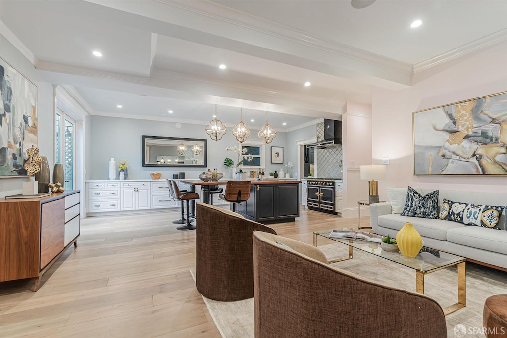 living room featuring ornamental molding and light wood-type flooring