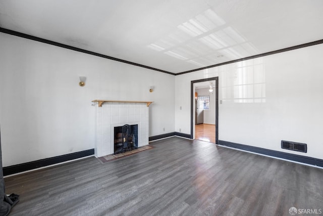 unfurnished living room featuring ornamental molding, visible vents, a tile fireplace, and wood finished floors