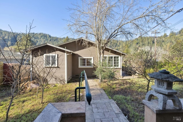 back of house with a mountain view