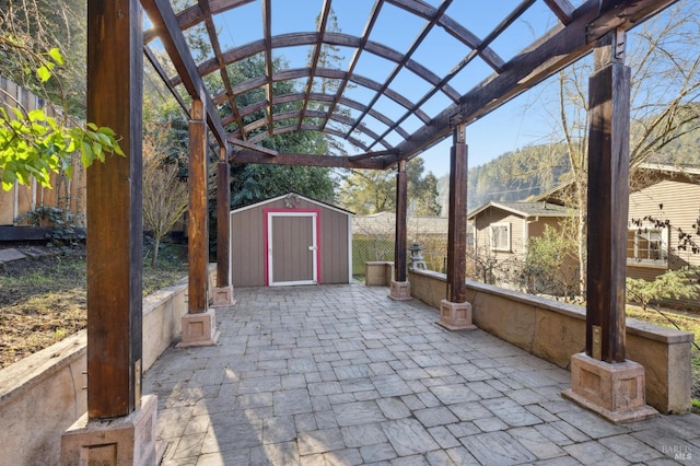 view of patio / terrace featuring a pergola and a shed