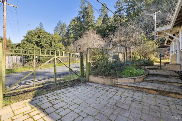 view of gate with a patio area