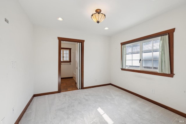 unfurnished bedroom featuring ensuite bath and carpet flooring