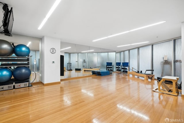 exercise room with wood finished floors