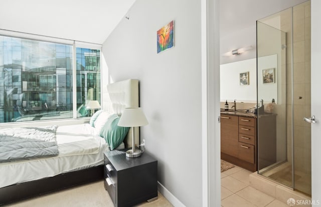 bedroom with a sink, baseboards, and light tile patterned floors