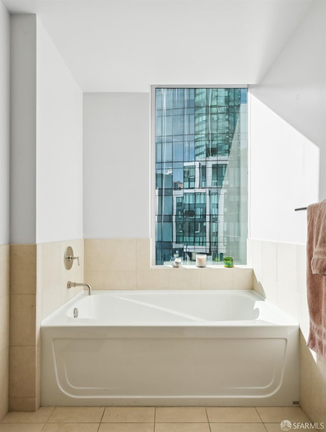 bathroom with tile patterned floors, tile walls, and a bath