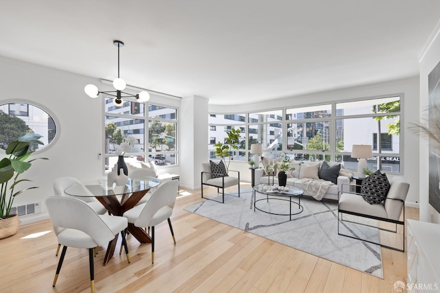 403 Main St Unit 215N, San Francisco, CA 94105 - living room featuring light wood-style floors, ornamental molding, a chandelier, and baseboards