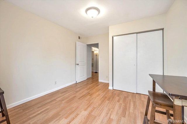 bedroom featuring light hardwood / wood-style flooring and a closet