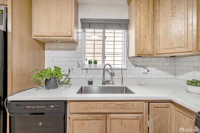 kitchen with light brown cabinetry, sink, and dishwasher