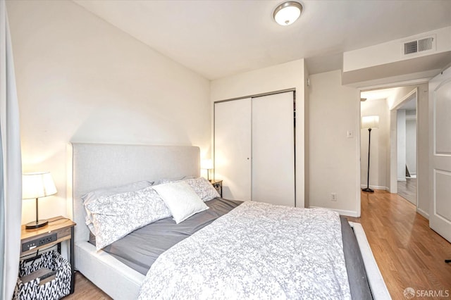 bedroom featuring light wood-type flooring and a closet