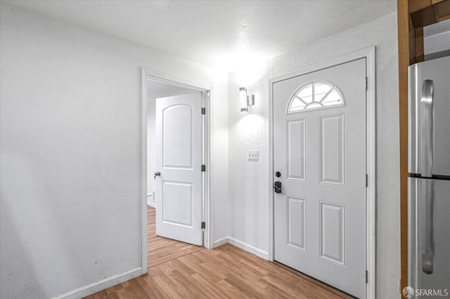 foyer entrance with light hardwood / wood-style flooring