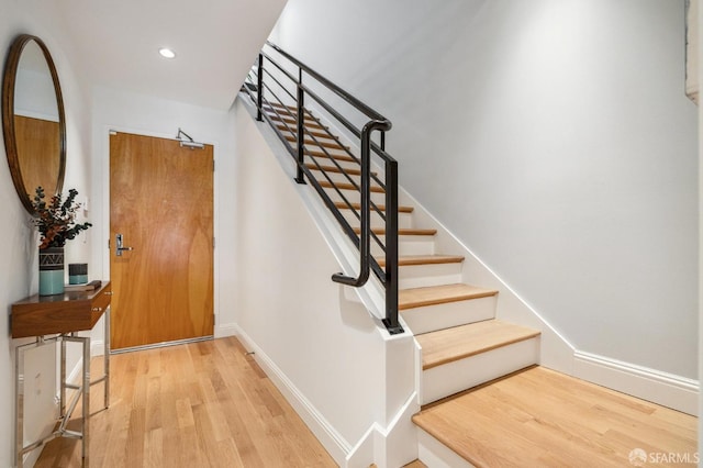 staircase with wood-type flooring